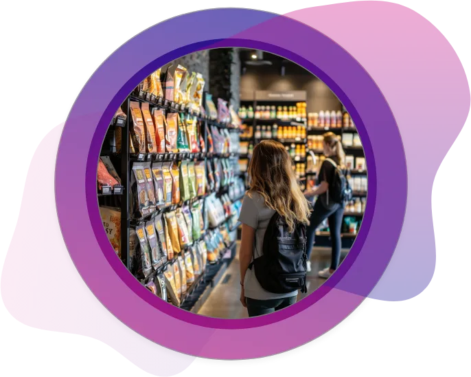 A young woman with a backpack browses a grocery store aisle filled with colorful stand-up pouches and custom food packaging on black shelves, showcasing evolving consumer packaging trends.