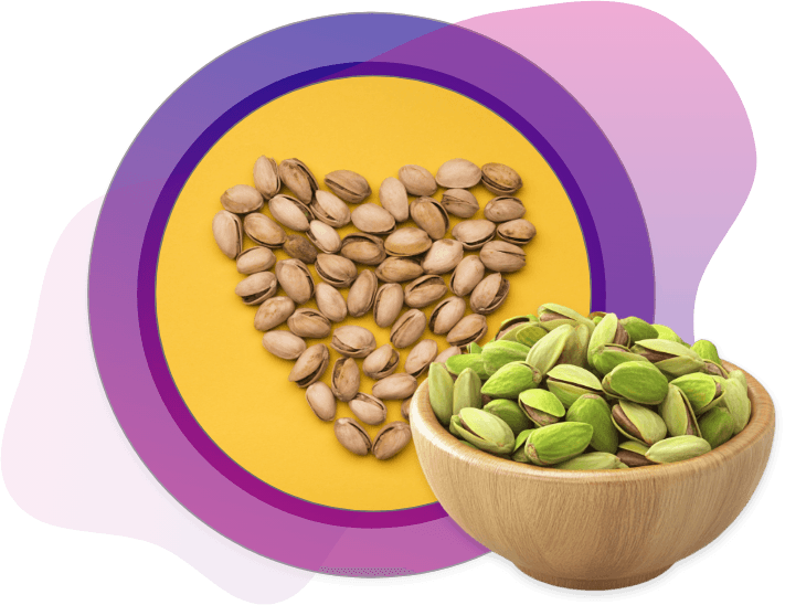 Heart shape made of empty pistachio shells on yellow background with fresh green pistachio kernels in a wooden bowl, symbolizing love for healthy snacks.
