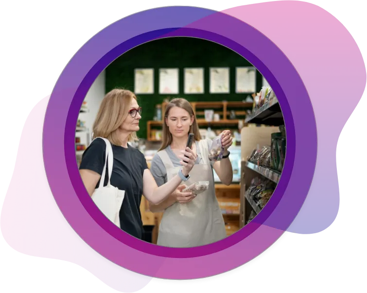 Customer and store associate reviewing food product packaging in a grocery aisle, emphasizing consumer engagement, custom printed packaging, point-of-sale experience, and product display design.