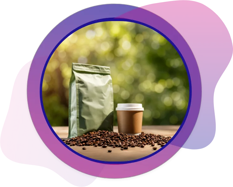 Matte green stand-up coffee bag paired with a paper coffee cup, surrounded by roasted coffee beans on an outdoor table setting.