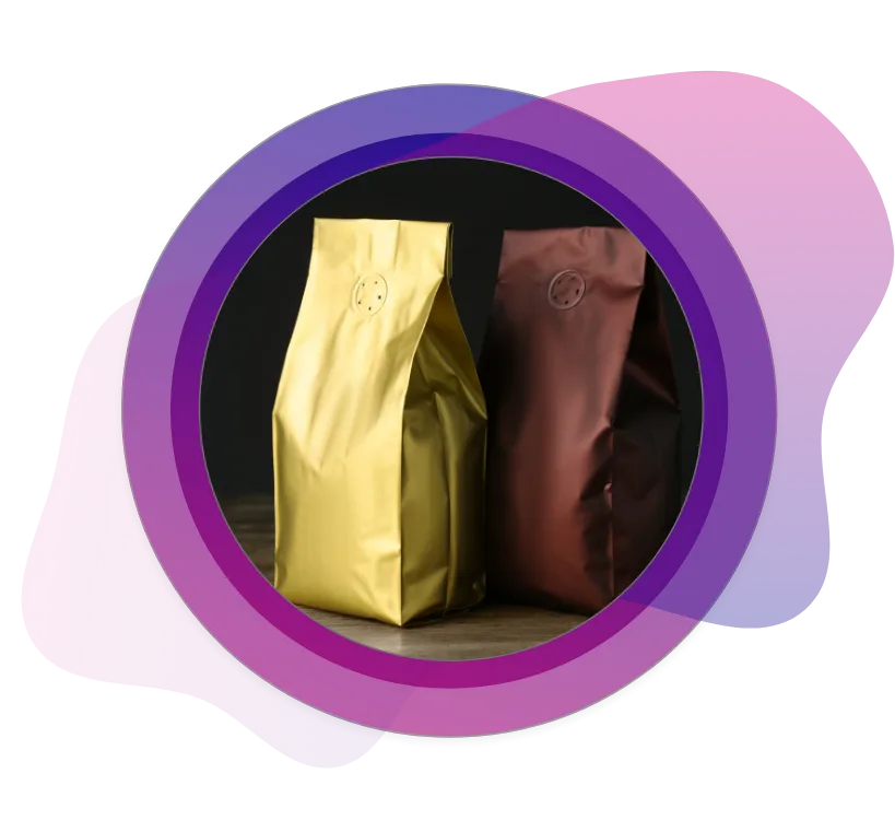 Two premium stand-up coffee bags in metallic gold and copper colors, each featuring a one-way degassing valve for preserving coffee bean freshness.