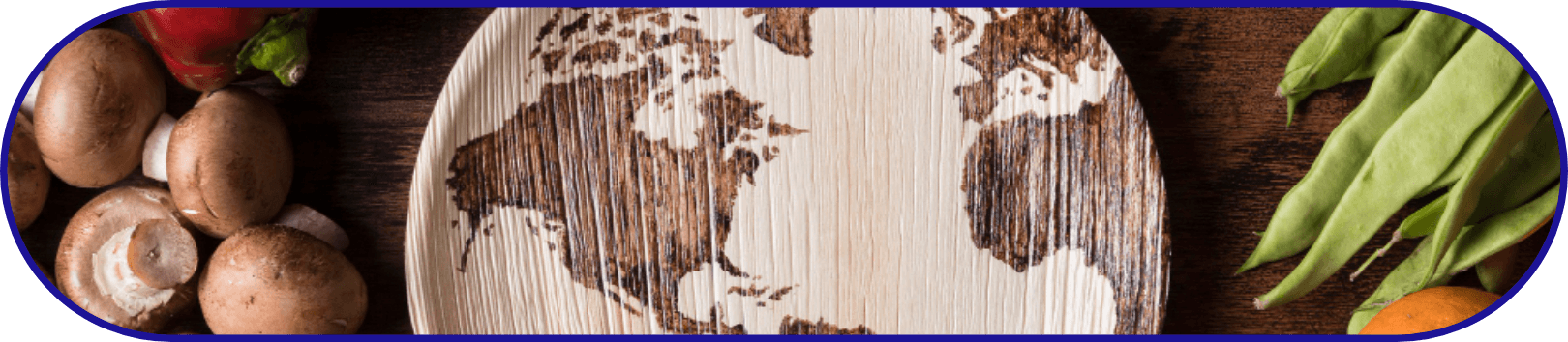 World map carved on a wooden surface surrounded by fresh vegetables, representing global food trade, FSMA import safety programs, and international compliance efforts.