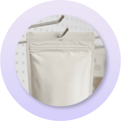 Close-up of a K-seal stand-up pouch with a hang hole feature displayed on retail hooks, illustrating merchandising options for pegboard displays and hanging retail environments.