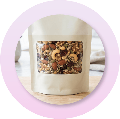 K-seal stand-up pouch featuring a transparent window that showcases trail mix inside the package, allowing consumers to view product quality while maintaining premium shelf appeal and barrier protection.